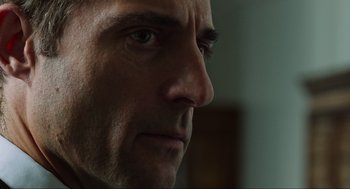 Movie still from “Zero Dark Thirty” (2012), directed by Kathryn Bigelow – A man's face in a dark room; Close Up shot, Over the shoulder angle