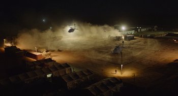 Movie still from “Zero Dark Thirty” (2012), directed by Kathryn Bigelow – A helicopter is flying over an airfield at night; Extreme Wide shot, High angle