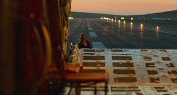 Movie still from “Zero Dark Thirty” (2012), directed by Kathryn Bigelow – A woman standing on a runway at night; Wide shot, Low angle