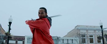 Movie still from “Zombieland: Double Tap” (2019), directed by Ruben Fleischer – A man in a red jacket swinging a baseball bat; Medium shot, Low angle