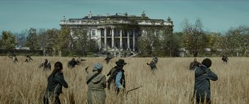 Movie still from “Zombieland: Double Tap” (2019), directed by Ruben Fleischer – A group of people standing in the middle of a field; Extreme Wide shot, Low angle