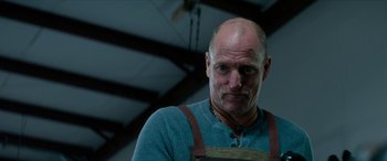 Movie still from “Zombieland: Double Tap” (2019), directed by Ruben Fleischer – A man with a beard wearing an overalls; Close Up shot, Low angle