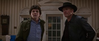 Movie still from “Zombieland: Double Tap” (2019), directed by Ruben Fleischer – Two men standing next to each other in front of a building; Medium shot, Over the shoulder angle