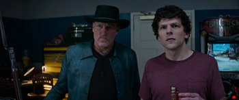 Movie still from “Zombieland: Double Tap” (2019), directed by Ruben Fleischer – A man and a boy standing next to each other in a room; Medium shot, Over the shoulder angle