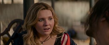 Movie still from “Zombieland: Double Tap” (2019), directed by Ruben Fleischer – A person wearing a necklace; Close Up shot, Over the shoulder angle