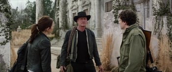 Movie still from “Zombieland: Double Tap” (2019), directed by Ruben Fleischer – An older man wearing a black hat and a black jacket; Medium shot, Over the shoulder angle