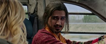 Movie still from “Zombieland: Double Tap” (2019), directed by Ruben Fleischer – A person with long brown hair; Close Up shot, Over the shoulder angle