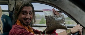 Movie still from “Zombieland: Double Tap” (2019), directed by Ruben Fleischer – A man holding a bag of food in his hand; Close Up shot, High angle