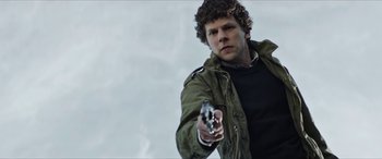 Movie still from “Zombieland: Double Tap” (2019), directed by Ruben Fleischer – A man holding a gun in his right hand; Medium shot, Low angle
