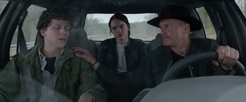 Movie still from “Zombieland: Double Tap” (2019), directed by Ruben Fleischer – A man and a woman sitting in the back of a car; Medium shot, Over the shoulder angle