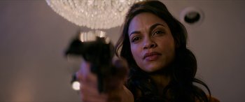 Movie still from “Zombieland: Double Tap” (2019), directed by Ruben Fleischer – A woman is holding a gun in her hand; Close Up shot, Over the shoulder angle