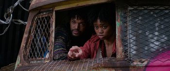 Movie still from “Zombieland: Double Tap” (2019), directed by Ruben Fleischer – A man and a woman looking out of a window; Close Up shot, Low angle