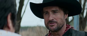 Movie still from “Zombieland: Double Tap” (2019), directed by Ruben Fleischer – A person wearing a cowboy hat; Close Up shot, Over the shoulder angle