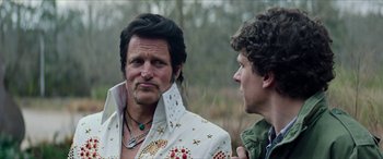 Movie still from “Zombieland: Double Tap” (2019), directed by Ruben Fleischer – A man in a white jacket and a man in a green jacket; Close Up shot, Over the shoulder angle