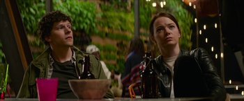 Movie still from “Zombieland: Double Tap” (2019), directed by Ruben Fleischer – Two people sitting at a table with a beer; Medium shot, Over the shoulder angle