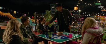 Movie still from “Zombieland: Double Tap” (2019), directed by Ruben Fleischer – A man standing at a table with a woman at a restaurant; Medium shot, Over the shoulder angle