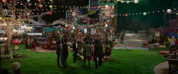 Movie still from “Zombieland: Double Tap” (2019), directed by Ruben Fleischer – A group of people standing in a field with lights in the background; Extreme Wide shot, High angle