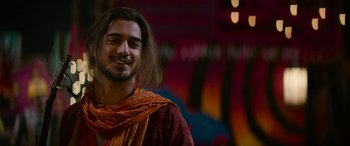 Movie still from “Zombieland: Double Tap” (2019), directed by Ruben Fleischer – A man with long brown hair wearing a scarf; Medium shot, Over the shoulder angle