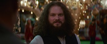 Movie still from “Zombieland: Double Tap” (2019), directed by Ruben Fleischer – A man with a long beard is smiling for the camera; Close Up shot, Low angle