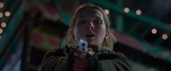 Movie still from “Zombieland: Double Tap” (2019), directed by Ruben Fleischer – A woman is holding a gun in her hand; Close Up shot, Low angle