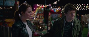 Movie still from “Zombieland: Double Tap” (2019), directed by Ruben Fleischer – A woman standing next to a man on a carnival ride; Medium shot, Over the shoulder angle