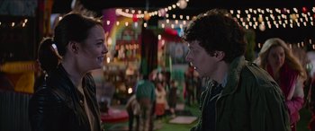Movie still from “Zombieland: Double Tap” (2019), directed by Ruben Fleischer – A man and a woman talking to each other in front of a crowd; Medium shot, Over the shoulder angle