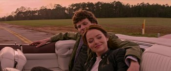 Movie still from “Zombieland: Double Tap” (2019), directed by Ruben Fleischer – A man and a woman sitting in the back of a car; Medium shot, Over the shoulder angle