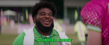 Movie still from “Zombies 3” (2022), directed by Paul Hoen – A man with a beard is smiling for the camera; Medium shot, High angle