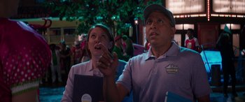 Movie still from “Zombies 3” (2022), directed by Paul Hoen – A man and a woman are watching something on a tv screen; Medium shot, Low angle