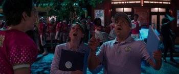 Movie still from “Zombies 3” (2022), directed by Paul Hoen – A man and a woman looking up at a crowd of onlookers; Medium shot, Low angle