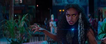 Movie still from “Zombies 3” (2022), directed by Paul Hoen – A woman with glowing yellow eyes is holding something in her hand; Close Up shot, Over the shoulder angle