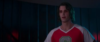 Movie still from “Zombies 3” (2022), directed by Paul Hoen – A man with green hair and a red and white shirt; Close Up shot, Over the shoulder angle