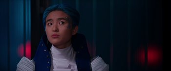 Movie still from “Zombies 3” (2022), directed by Paul Hoen – A person with blue hair looking up; Close Up shot, Over the shoulder angle