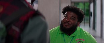 Movie still from “Zombies 3” (2022), directed by Paul Hoen – A man in a green shirt is looking up; Close Up shot, Over the shoulder angle