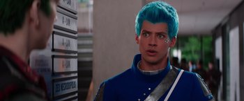 Movie still from “Zombies 3” (2022), directed by Paul Hoen – A man with blue hair is standing in a building; Close Up shot, Over the shoulder angle