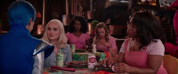 Movie still from “Zombies 3” (2022), directed by Paul Hoen – A group of people sitting at a table eating food; Medium shot, Over the shoulder angle