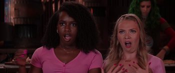 Movie still from “Zombies 3” (2022), directed by Paul Hoen – Two women standing next to each other in front of a building; Close Up shot, Low angle