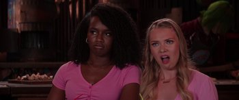 Movie still from “Zombies 3” (2022), directed by Paul Hoen – Two young women standing next to each other; Close Up shot, Over the shoulder angle