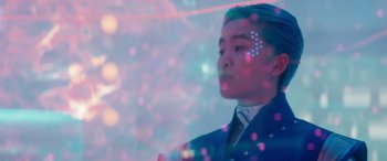 Movie still from “Zombies 3” (2022), directed by Paul Hoen – A man in a blue suit and a white dot on his forehead; Close Up shot, Low angle