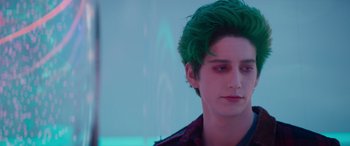 Movie still from “Zombies 3” (2022), directed by Paul Hoen – A man with green hair is looking at the camera; Close Up shot, Over the shoulder angle