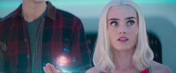 Movie still from “Zombies 3” (2022), directed by Paul Hoen – A woman holding a cell phone in front of a man; Close Up shot, Over the shoulder angle