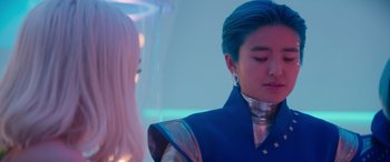 Movie still from “Zombies 3” (2022), directed by Paul Hoen – A man and a woman in blue and silver outfits; Close Up shot, Over the shoulder angle