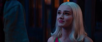 Movie still from “Zombies 3” (2022), directed by Paul Hoen – A woman's face in front of a building; Close Up shot, Over the shoulder angle