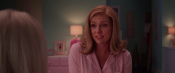 Movie still from “Zombies 3” (2022), directed by Paul Hoen – A woman with blonde hair wearing a pink and white striped shirt; Close Up shot, Over the shoulder angle