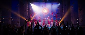 Movie still from “Zombies 3” (2022), directed by Paul Hoen – A group of people on a stage performing a dance; Extreme Wide shot, Low angle