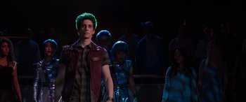 Movie still from “Zombies 3” (2022), directed by Paul Hoen – A group of people standing in a dark room; Medium shot, Over the shoulder angle