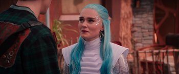 Movie still from “Zombies 3” (2022), directed by Paul Hoen – A woman with blue hair is wearing a white outfit; Close Up shot, Over the shoulder angle