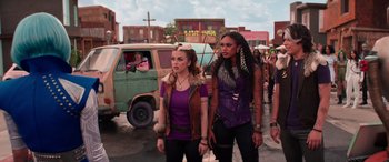 Movie still from “Zombies 3” (2022), directed by Paul Hoen – A couple of women standing next to each other on a street; Medium shot, Over the shoulder angle