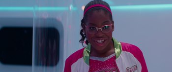 Movie still from “Zombies 3” (2022), directed by Paul Hoen – A young girl wearing glasses and a pink and white outfit; Close Up shot, Over the shoulder angle