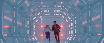 Movie still from “Zombies 3” (2022), directed by Paul Hoen – A man and a woman holding hands while walking through a tunnel; Wide shot, Low angle